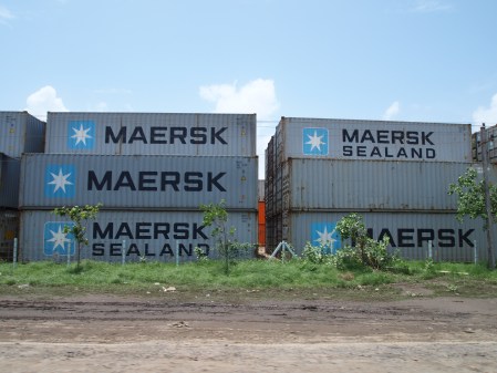 containers stacked outside adani's mundra port.
