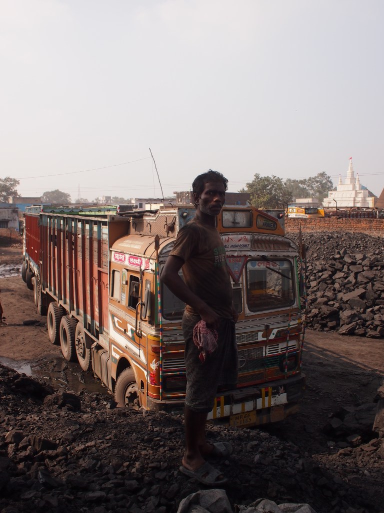 preparing to move coal from one truck to another. 